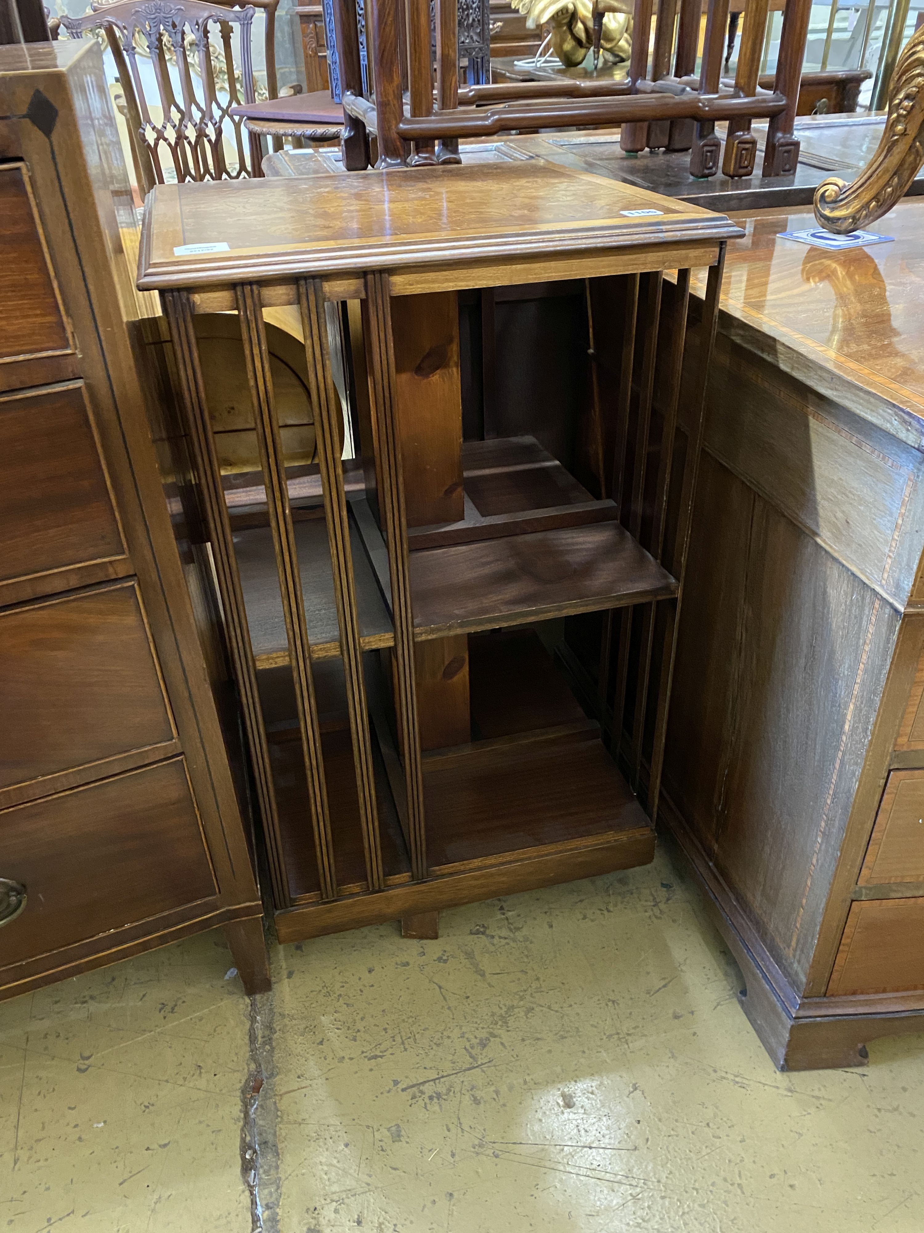 An Edwardian square cross banded elm revolving bookcase, width 48cm, height 83cm